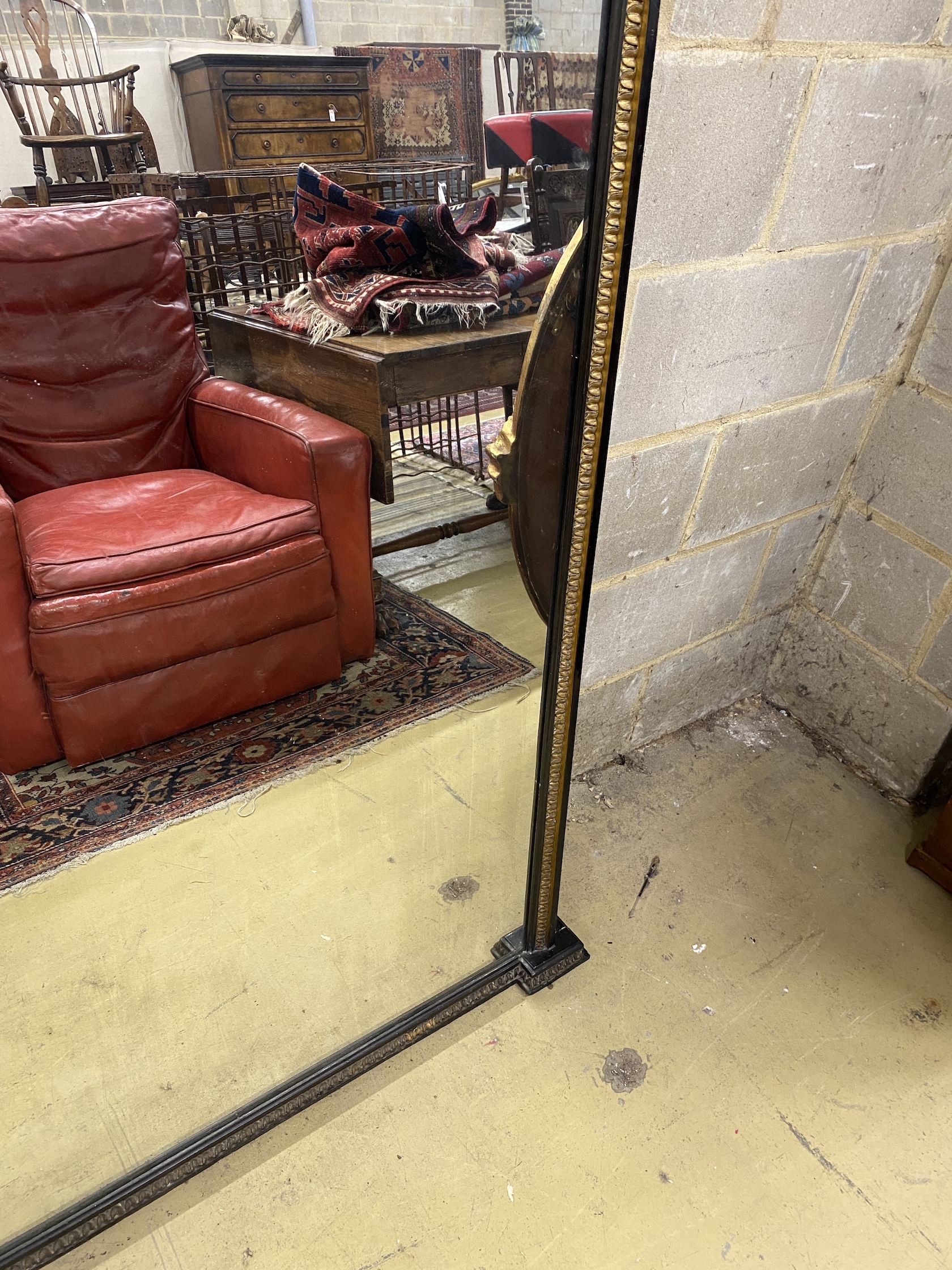 A late Victorian ebonised parcel gilt overmantel mirror, width 151cm, height 154cm